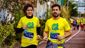 Two athletes participating in a marathon, showing determination and joy.